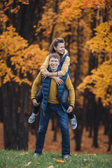 A happy couple having fun in autumn park
