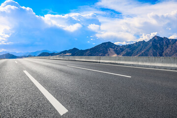 Asphalt road and mountain with sky clouds landscape.