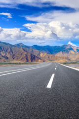 Asphalt road and mountain with sky clouds landscape.