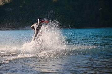 triathlon athlete starting swimming training on lake