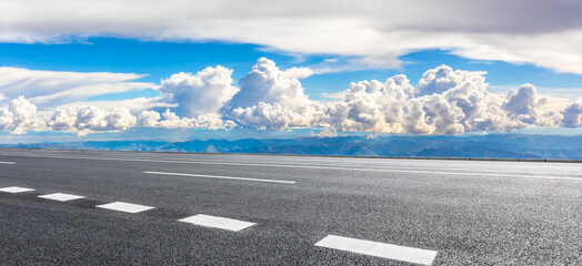 Fototapeta premium Asphalt road and mountain with sky clouds landscape.