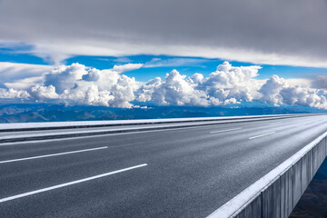 Fototapeta premium Asphalt road and mountain with sky clouds landscape.