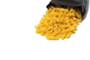 pasta close-up on a white background. Pasta spilled out of the package.