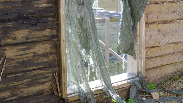 The broken and stripped cloth on the window in Estonia