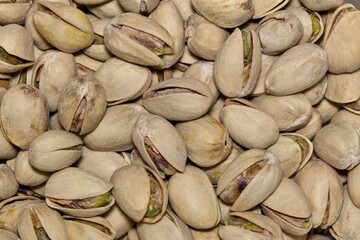 Pistachio nuts scattered close up macro image. The trees are native to Asia and the Middle East.