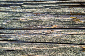 Woodgrain detail of a weathered picnic table