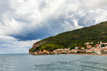 Public beach of Petrovac town with fortress. 
