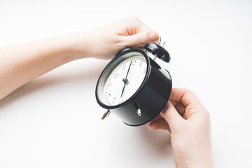close up of a young European girl adjusting the time of the clock