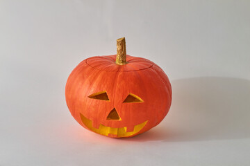 Making the head of Jack Lantern from a pumpkin. Step 7 -
insert a paraffin candle into the pumpkin and light it. Cover the pumpkin with the cut top. Pumpkin for Halloween on a white background