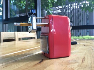 
Red pencil sharpener on wooden table