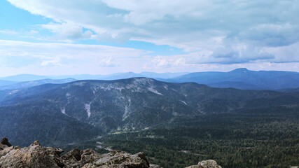 Landscape of scenic mountain forest background and peak of blue rock range.