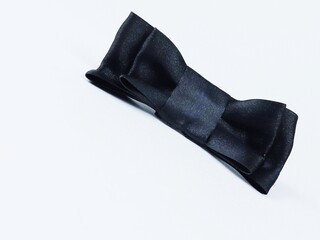 Black bow tie isolated on a white background. Butterfly bow decoration, hair decoration