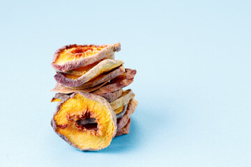 slices of dried peach on a blue background. dried fruits. eco.