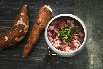 Cooked tapioca or Cassava root , Mandioca or Aipim with spicy fish meat beef pork curry, Kerala, India. Prepared  South Indian food, Kappa Puzhukku, served with chutney. root vegetable Brazil.