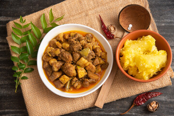 Cooked tapioca or Cassava root , Mandioca or Aipim with spicy fish meat beef pork curry, Kerala, India. Prepared  South Indian food, Kappa Puzhukku  served with chutney. root vegetable Brazil.