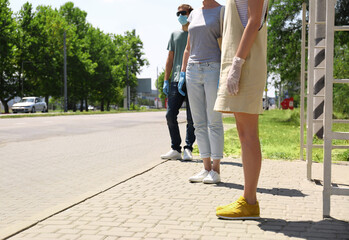 Fototapeta premium People keeping social distance in line at bus stop. Coronavirus pandemic
