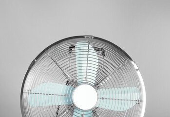 Electric fan on light grey background. Summer heat
