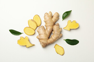 Fresh raw ginger and leaves on white background
