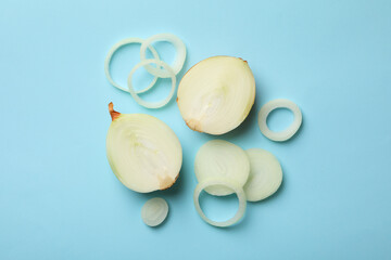 Fresh onion on blue background, top view