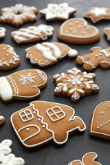 Many different delicious Christmas cookies on black table