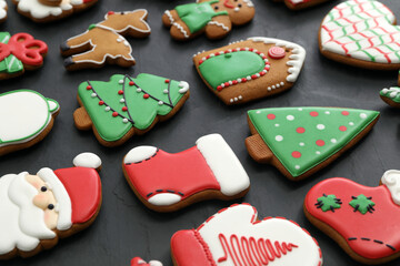 Many different delicious Christmas cookies on black table