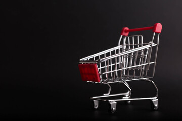 Black Friday concept. Empty shopping cart isolated on black background