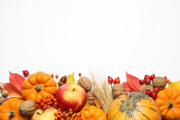 Flat lay composition with ripe pumpkins and autumn leaves on white background, space for text....