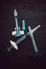 Medical injection syringes with solution on black background