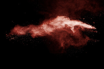 Brown powder explosion on black background.
