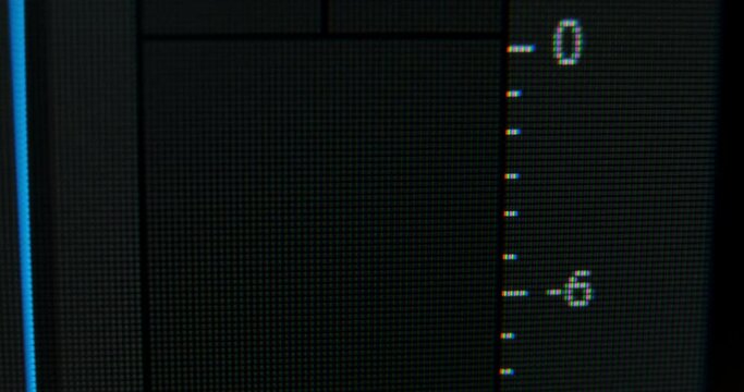 Yellow digital indicator audio control panels show exceeding level of sound of left and right channels during playback macro view