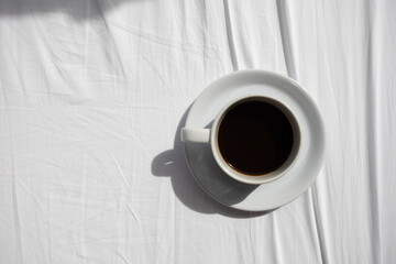 Top view Black coffee cup on a white cloth bed