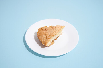 pattern of apple pie slices on white plate on blue background. trendy food pattern with shadow