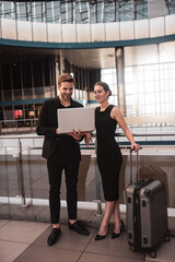 Colleagues working with the computer during the business trip