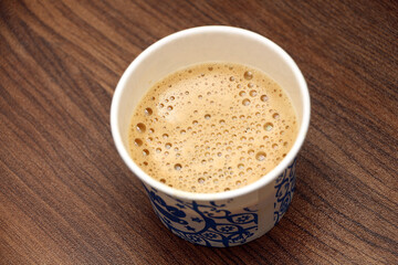 Tea with foam in a Paper cup