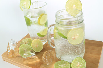 Health care, fitness, healthy nutrition diet concept. Fresh cool lemon infused water, detox drink, lemonade in a glass jug and a glass.