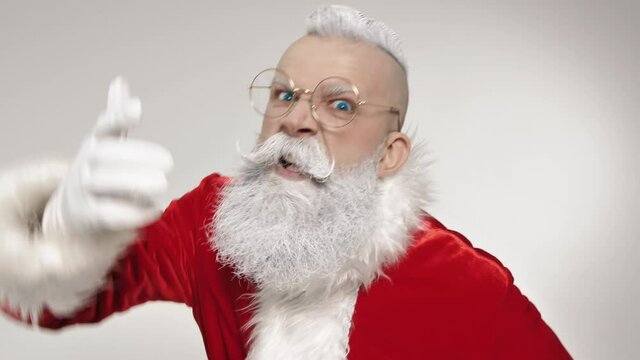 Angry mad displeased Santa Claus screams, scolds kid for bad behavior, looking at camera at white background closeup indoors. Aggressive negative emotions, annoyed furious expression of shouting face
