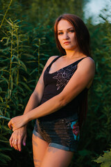 Portrait of a beautiful girl on a background of grass.