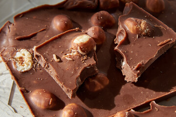 Chocolate with whole nuts eaten by small worms.