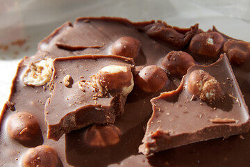 Chocolate with whole nuts eaten by small worms.