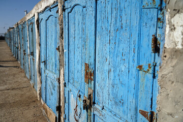 Old blue painted fishing garage in historic port in Morocco