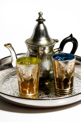 Group of teapot and glasses of oriental tea on a tray on white background