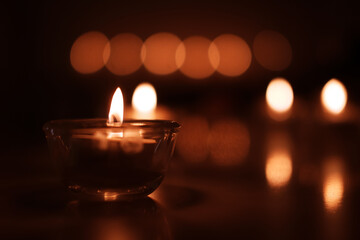 Candle light in Glass cup decoration in spa and christmas night party in Bokeh background. Holiday and Romantic love on valentines day Concept.