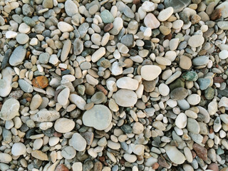 Colored stones. Stones on the beach. Small and big stones on the beach.