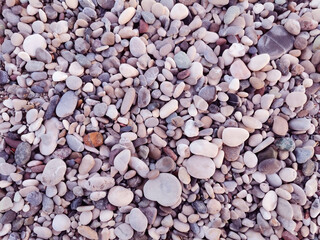 Colored stones. Stones on the beach. Small and big stones on the beach.