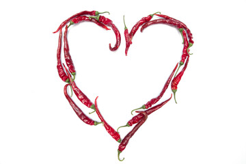 Heart of small chili peppers isolated on a white background. Copyspace for text.