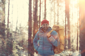 winter landscape man with a backpack / nature landscape a man on a hike with equipment in snowy weather in Canada