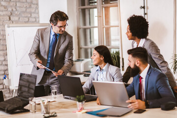 Multi-ethnic group of happy business people having a meeting in modern office.