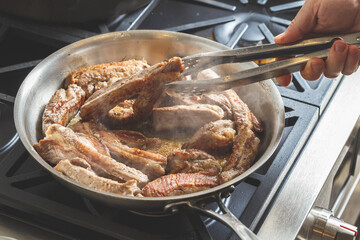 Chef cooking pork baby back ribs meat