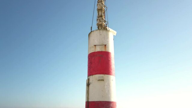 The two sides of Restinga de Ofir. The Ronca de Esposende, a red and white colored beacon alerts on the pier, Portugal.