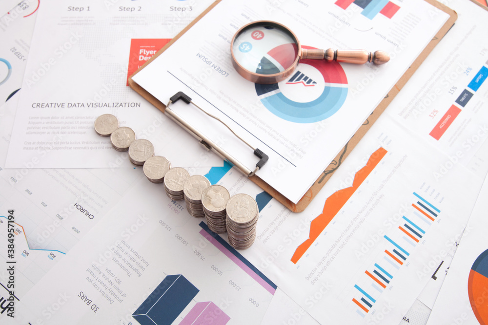 Canvas Prints Folder and magnifying glass and a row of increasing dollar coins on the background of financial documents